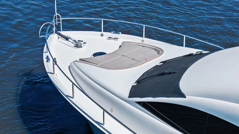  Yacht Photos Pics 2005 Lazzara 68 Pilothouse Motoryacht on water, showcasing sleek deck design.