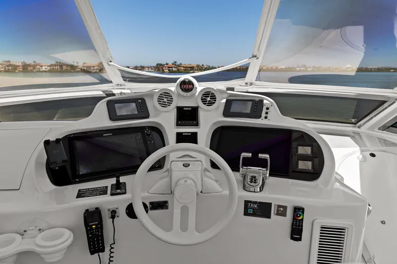  Yacht Photos Pics Pilothouse of 2005 Lazzara 68 Motoryacht with modern navigation equipment and steering wheel.