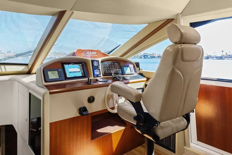  Yacht Photos Pics Pilothouse interior of 2005 Lazzara 68 Motoryacht with navigation controls and captain's chair.