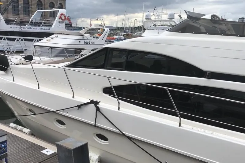 Bianca Lucida Yacht Photos Pics 1999 Azimut 58 yacht docked at marina, showcasing sleek design and modern features.