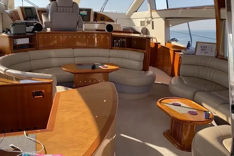 Bianca Lucida Yacht Photos Pics Luxurious interior of a 1999 Azimut 58 yacht with elegant seating and wooden accents.