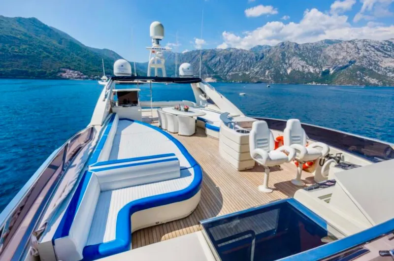 Lady Mura Yacht Photos Pics Luxurious 2010 Dominator 29M yacht deck with seating, overlooking scenic mountains and blue waters.