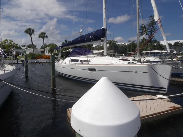 Magic Carpet Yacht Photos Pics 2010 Jeanneau Sun Odyssey 36i sailboat docked in a sunny marina setting.