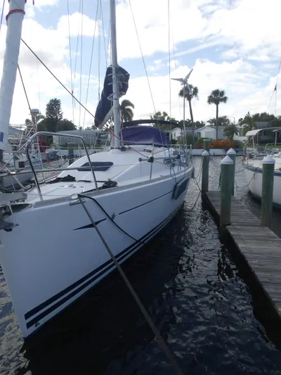 Magic Carpet Yacht Photos Pics 2010 Jeanneau Sun Odyssey 36i sailboat docked at marina, clear sky background.