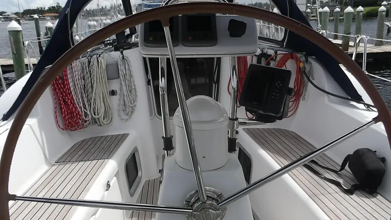 Magic Carpet Yacht Photos Pics Cockpit of 2010 Jeanneau Sun Odyssey 36i sailboat with steering wheel and ropes.