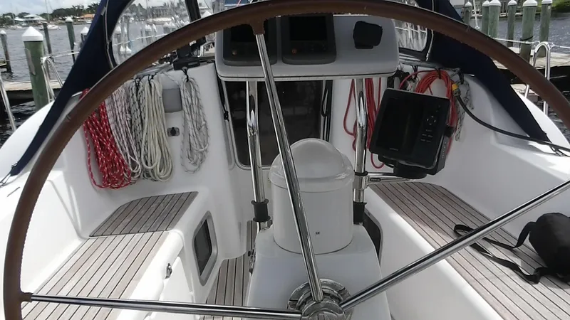 Magic Carpet Yacht Photos Pics Cockpit of 2010 Jeanneau Sun Odyssey 36i sailboat with steering wheel and navigation equipment.