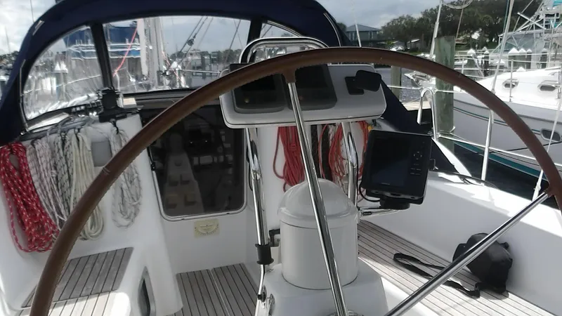 Magic Carpet Yacht Photos Pics Cockpit of 2010 Jeanneau Sun Odyssey 36i sailboat with steering wheel and navigation equipment.