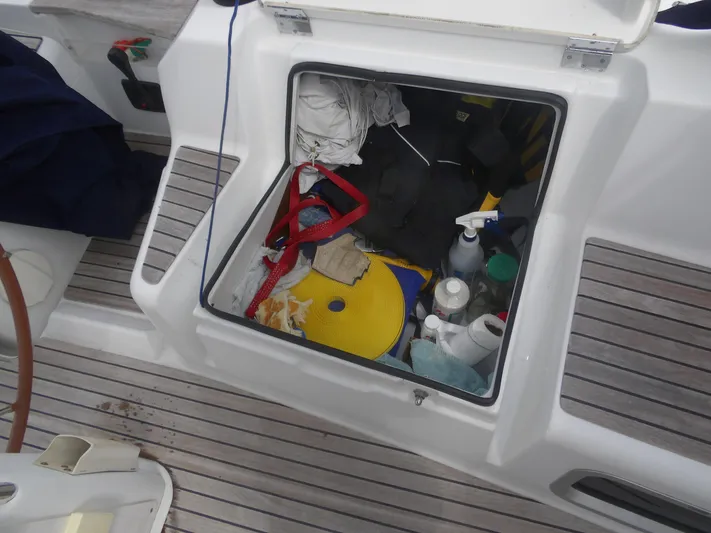 Magic Carpet Yacht Photos Pics Open storage compartment on 2010 Jeanneau Sun Odyssey 36i sailboat, containing various supplies and equipment.