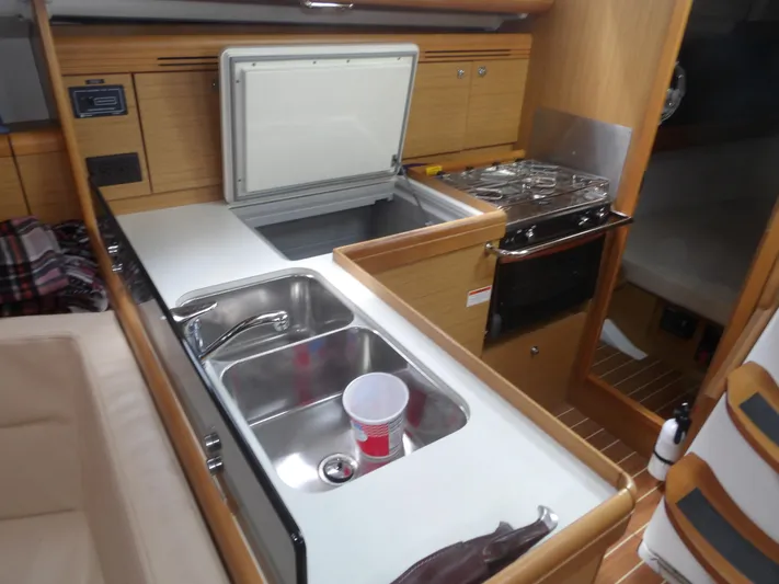 Magic Carpet Yacht Photos Pics Galley of 2010 Jeanneau Sun Odyssey 36i yacht with sink, stove, and storage.