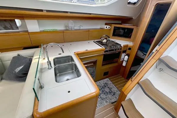 Rising Sun Yacht Photos Pics Interior of 2016 Jeanneau Sun Odyssey 50 DS yacht with modern kitchen amenities.