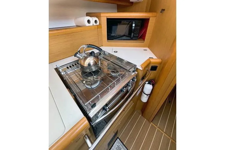 Rising Sun Yacht Photos Pics Galley of 2016 Jeanneau Sun Odyssey 50 DS with stove, kettle, and microwave.