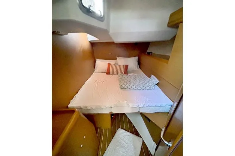 Rising Sun Yacht Photos Pics Cozy cabin interior of 2016 Jeanneau Sun Odyssey 50 DS sailboat with comfortable bedding.