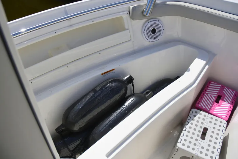  Yacht Photos Pics 2024 Pursuit DC 246 Dual Console boat storage area with fenders and accessories.