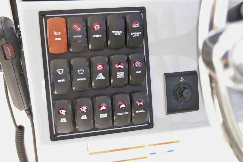  Yacht Photos Pics Control panel of 2024 Pursuit DC 246 Dual Console boat with labeled switches.