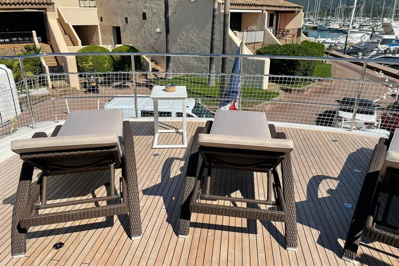 Mira Yacht Photos Pics Sun loungers on the deck of a 2013 Princess 98 Motor Yacht in a marina.