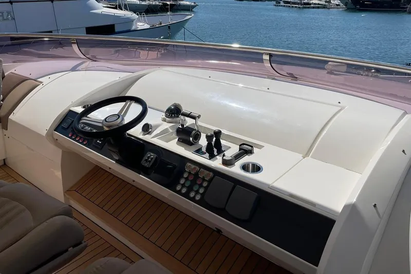 Mira Yacht Photos Pics Control panel of a 2013 Princess 98 Motor Yacht with steering wheel and navigation controls.
