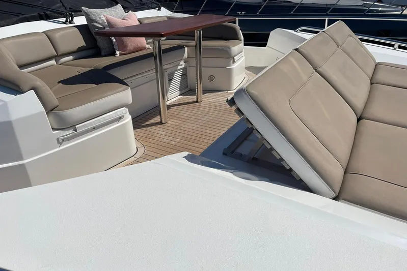 Mira Yacht Photos Pics Luxurious seating area on 2013 Princess 98 Motor Yacht with elegant cushions and table.