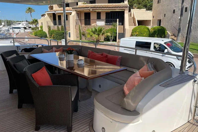 Mira Yacht Photos Pics Luxurious seating area on 2013 Princess 98 Motor Yacht with elegant table and cushions.