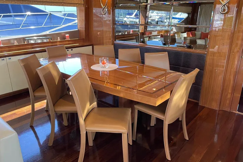 Mira Yacht Photos Pics Luxurious dining area on 2013 Princess 98 Motor Yacht with elegant wooden table and leather chairs.