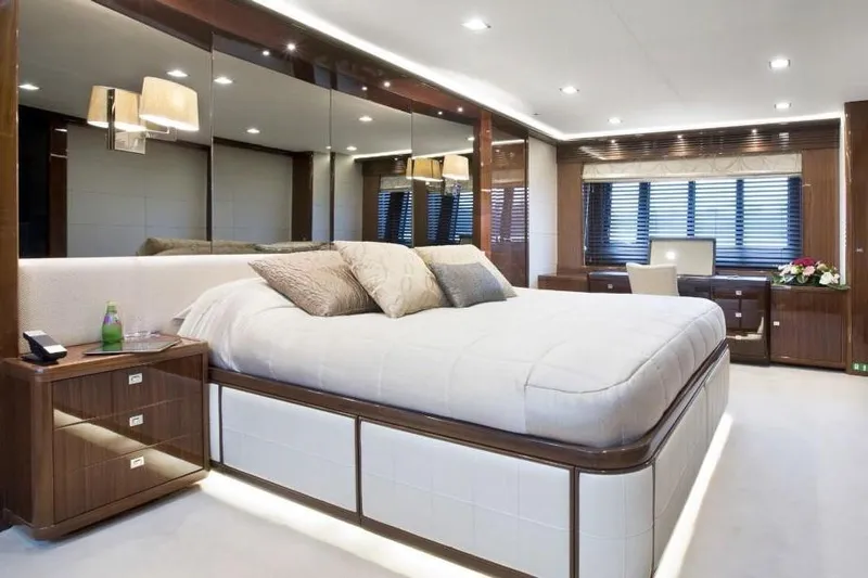 Mira Yacht Photos Pics Luxurious bedroom interior on 2013 Princess 98 Motor Yacht, featuring elegant wood finishes and modern decor.