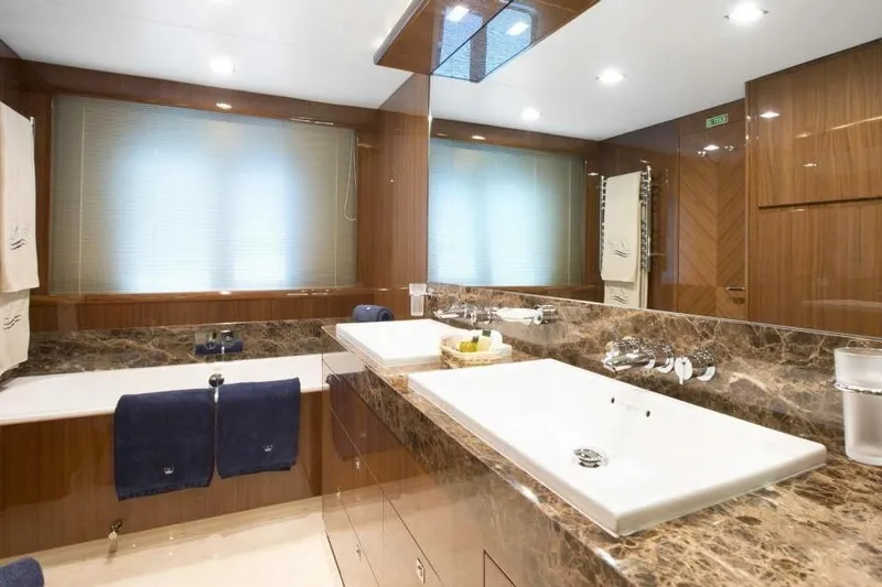 Mira Yacht Photos Pics Luxurious bathroom on 2013 Princess 98 Motor Yacht with marble countertops and modern fixtures.