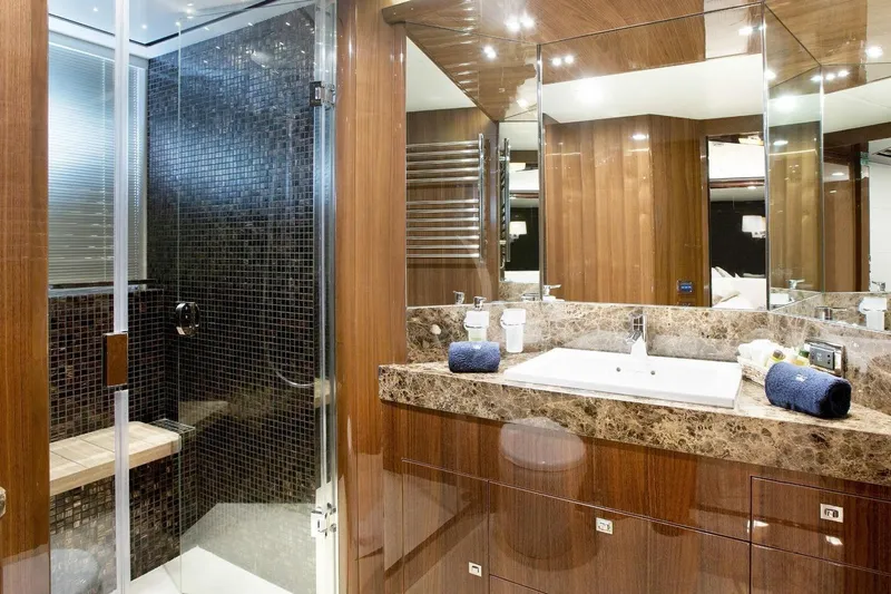 Mira Yacht Photos Pics Luxurious bathroom on 2013 Princess 98 Motor Yacht with marble countertop and glass shower.