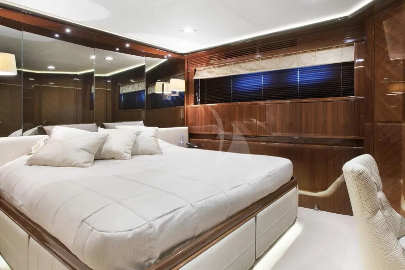 Mira Yacht Photos Pics Luxurious bedroom interior of 2013 Princess 98 Motor Yacht with elegant wood paneling.