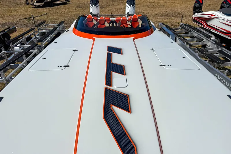  Yacht Photos Pics 2021 MTI 390X powerboat with sleek design and vibrant orange accents on trailer.