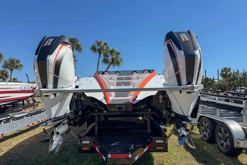  Yacht Photos Pics 2021 MTI 390X boat with dual outboard engines on a trailer, palm trees in background.