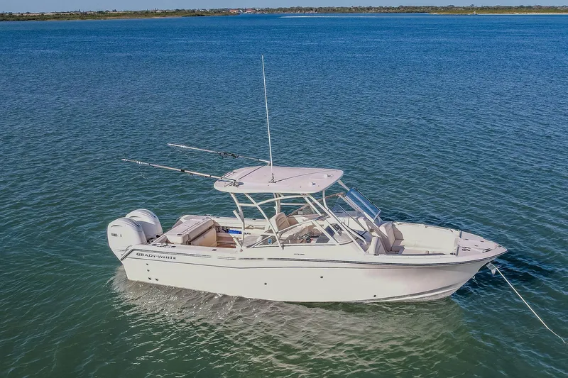 Fin & Tonic Yacht Photos Pics 2024 Grady-White Freedom 275 boat on calm blue water.