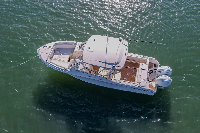 Fin & Tonic Yacht Photos Pics 2024 Grady-White Freedom 275 boat on water, aerial view, sunny day.