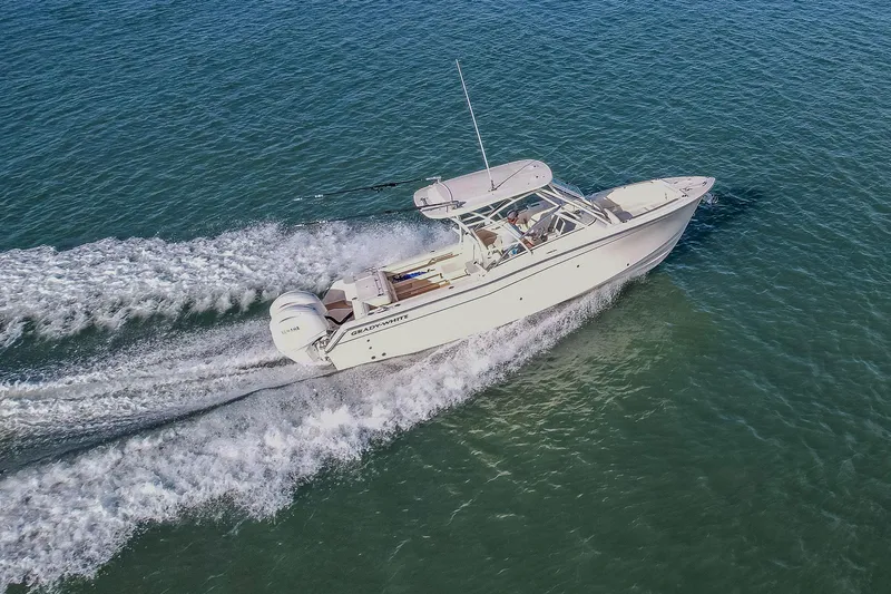 Fin & Tonic Yacht Photos Pics 2024 Grady-White Freedom 275 boat cruising on open water, aerial view.