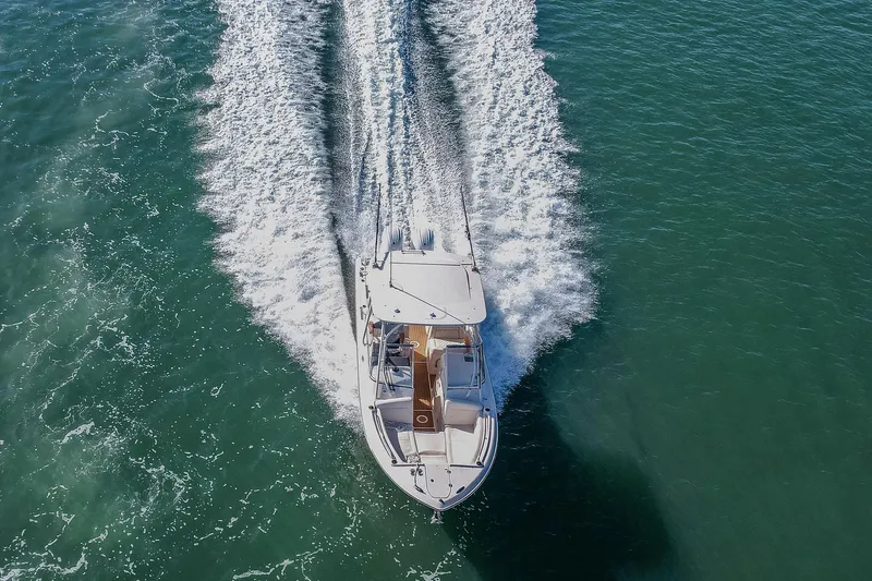 Fin & Tonic Yacht Photos Pics 2024 Grady-White Freedom 275 boat cruising on open water, aerial view.