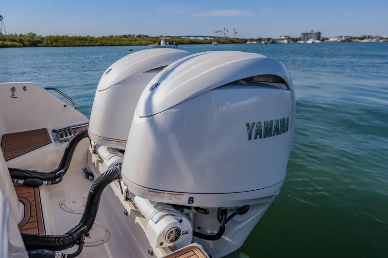 Fin & Tonic Yacht Photos Pics 2024 Grady-White Freedom 275 boat with dual Yamaha outboard engines on water.