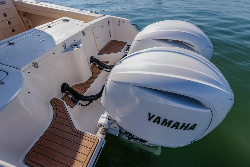 Fin & Tonic Yacht Photos Pics 2024 Grady-White Freedom 275 boat with dual Yamaha outboard engines on water.