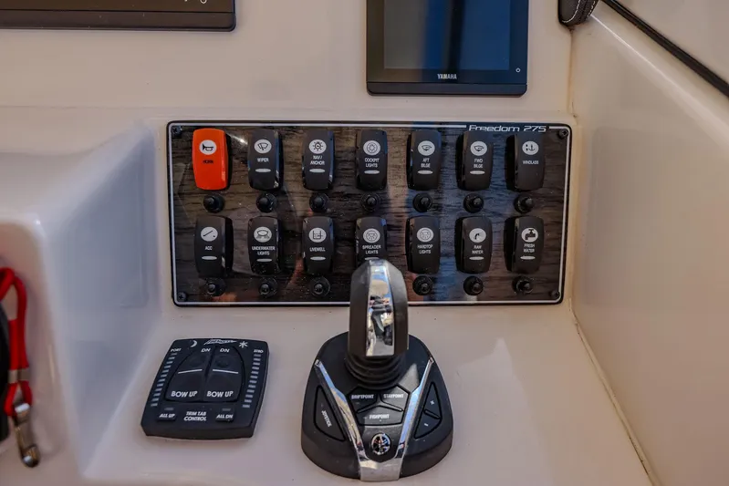 Fin & Tonic Yacht Photos Pics Control panel of 2024 Grady-White Freedom 275 boat with switches and joystick.