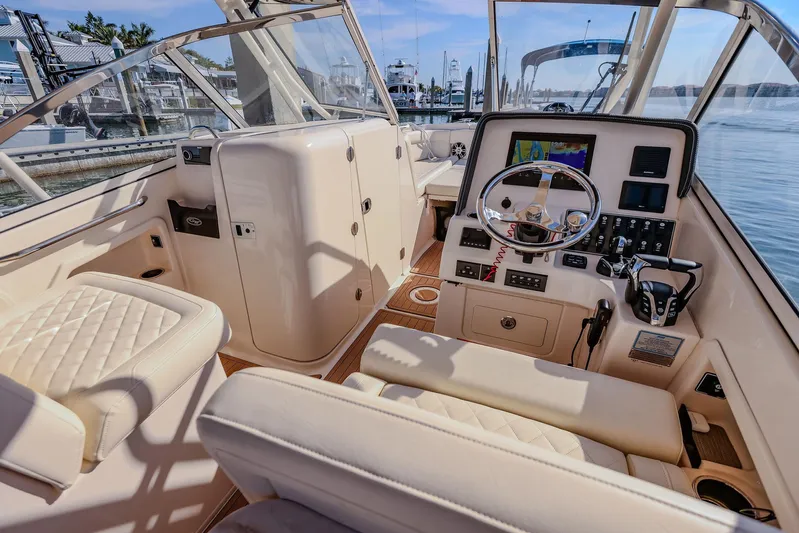 Fin & Tonic Yacht Photos Pics 2024 Grady-White Freedom 275 boat interior with helm, seating, and navigation equipment.
