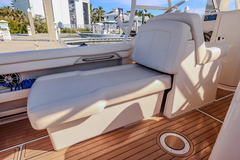 Fin & Tonic Yacht Photos Pics 2024 Grady-White Freedom 275 boat interior with luxurious seating and wooden deck.