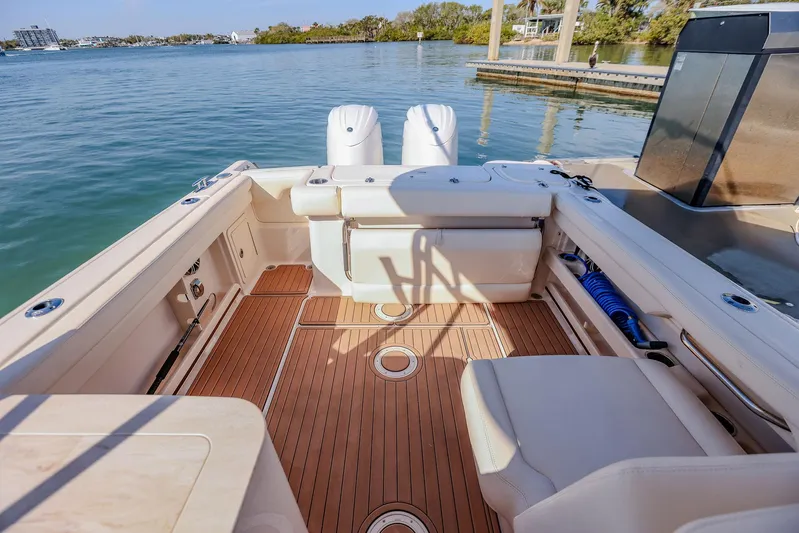 Fin & Tonic Yacht Photos Pics 2024 Grady-White Freedom 275 boat interior with teak flooring and dual engines.