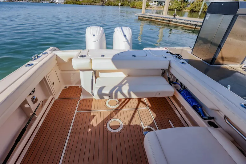 Fin & Tonic Yacht Photos Pics 2024 Grady-White Freedom 275 boat interior with teak flooring and dual engines.