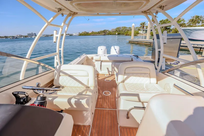 Fin & Tonic Yacht Photos Pics 2024 Grady-White Freedom 275 boat interior with luxurious seating and scenic waterfront view.