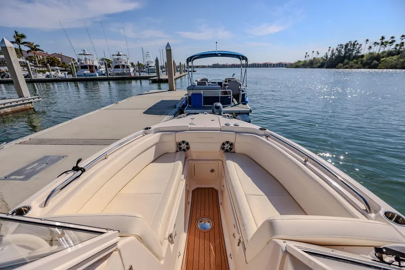Fin & Tonic Yacht Photos Pics 2024 Grady-White Freedom 275 boat docked at a marina under clear blue skies.
