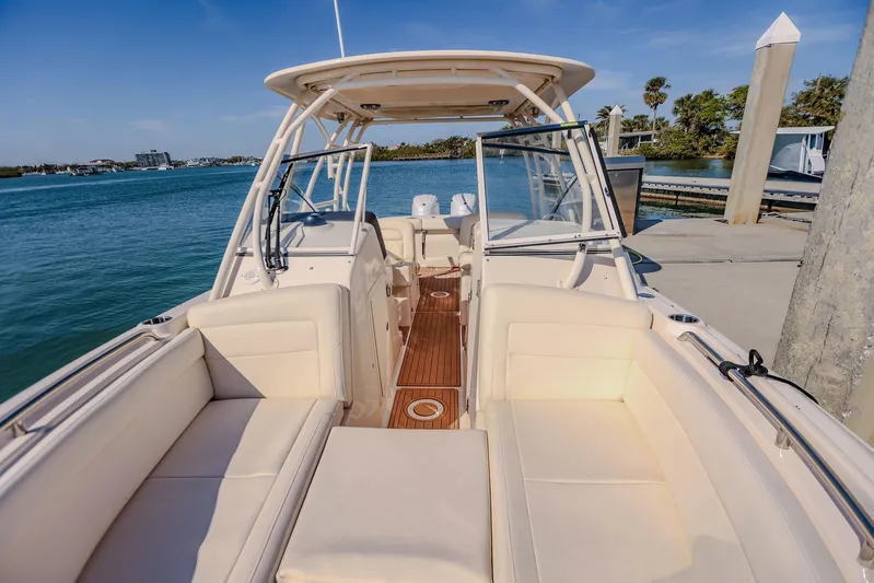 Fin & Tonic Yacht Photos Pics 2024 Grady-White Freedom 275 boat docked, featuring spacious seating and sleek design.