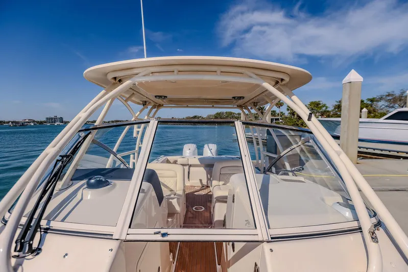 Fin & Tonic Yacht Photos Pics 2024 Grady-White Freedom 275 boat docked, showcasing spacious deck and sleek design.