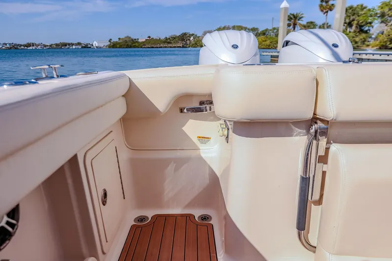 Fin & Tonic Yacht Photos Pics 2024 Grady-White Freedom 275 boat interior with teak flooring and dual engines.