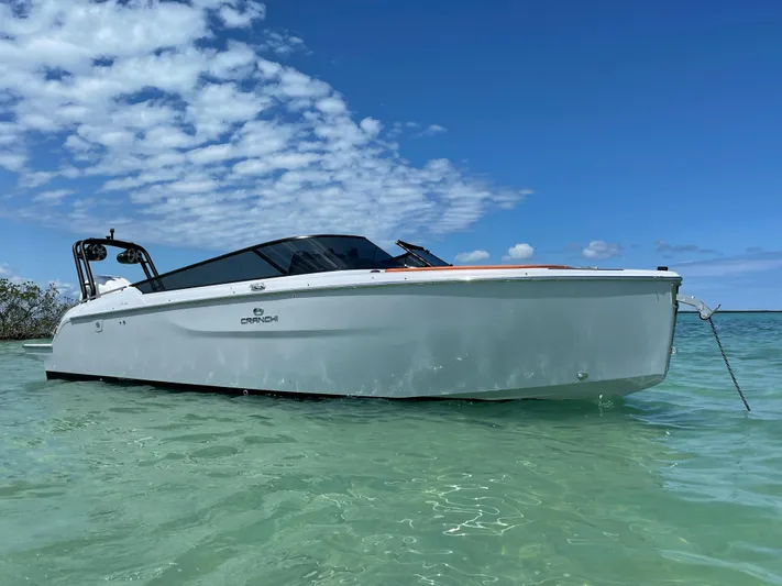 #0063 Bianca Panarea Yacht Photos Pics 2022 Cranchi 26 Rider boat anchored in clear turquoise water under a blue sky.