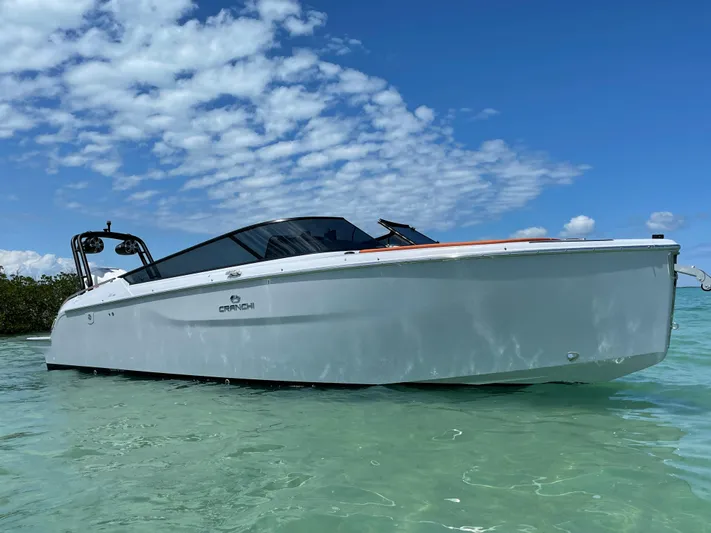 #0063 Bianca Panarea Yacht Photos Pics 2022 Cranchi 26 Rider boat in clear water under a blue sky.