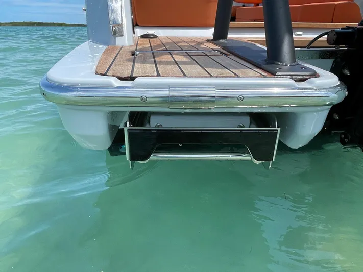 #0063 Bianca Panarea Yacht Photos Pics 2022 Cranchi 26 Rider boat stern with teak deck in clear turquoise water.