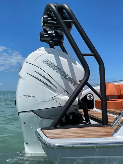 #0063 Bianca Panarea Yacht Photos Pics 2022 Cranchi 26 Rider boat with Mercury engine, docked on calm water.