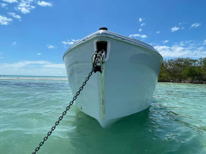 #0063 Bianca Panarea Yacht Photos Pics 2022 Cranchi 26 Rider boat anchored in clear turquoise water under a blue sky.